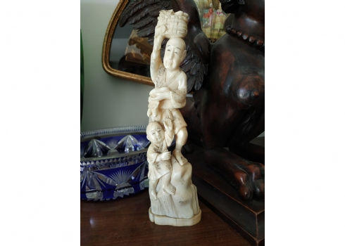 פסל שנהב יפני עתיק בדמות רוכל ירקות עם סל על ראשו ובנו לצידו