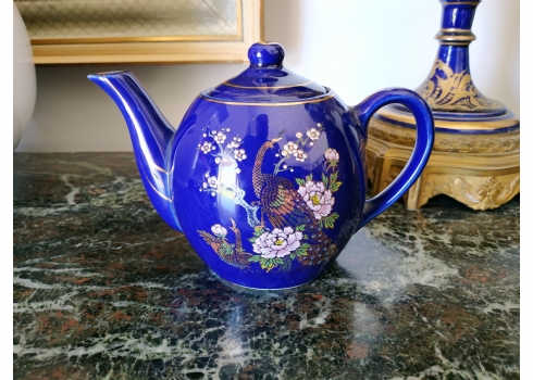 קומקום תה יפני קטן עשוי פורצלן מעוטר בדמות טווס גאה על רקע קובלט כחול וזהב