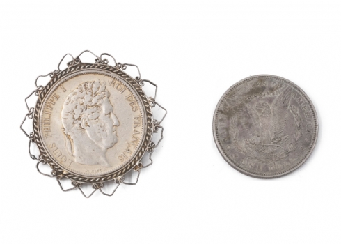 שני פרטי כסף עתיקים (סיכה משובצת מטבע ומטבע אמריקאי)