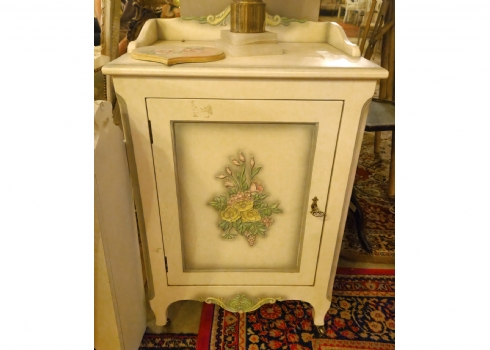 ארונית עץ בסגנון עתיק עם עיטורי פרחים על רקע בגוון שמנת