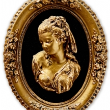 תבליט אובלי לתליה על הקיר בדמות נערה ושושנים בשערה, משולב קטיפה שחורה