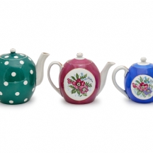 שלושה קומקומי פורצלן שונים, יצרנים ודגמים שונים, מעוטרים וחתומים